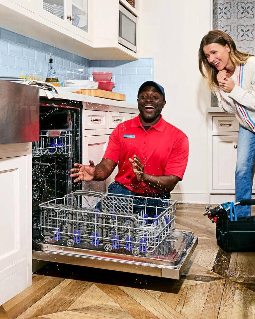 Woman looking at washing machine in surprise